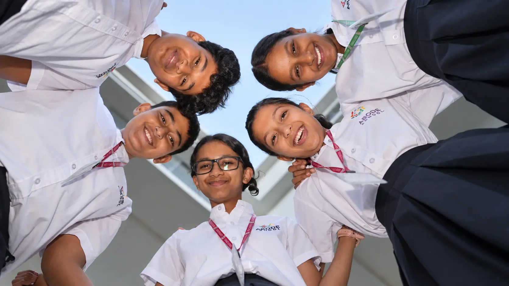 ABODE students smiling together in a circle